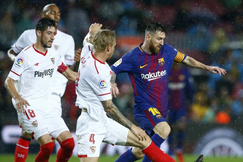 Lionel Messi, playing for Barcelona, duels with Simon Kjaer and his Sevilla teammates during a La Liga match. Messi has pledged to go on a religious pilgrimage if Argentina win the 2018 World Cup. Photo: AP