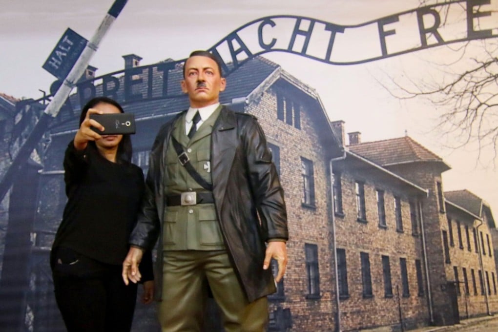 An Indonesian woman takes a selfie with the Hitler model at the museum in Yogyakarta. Photo: AFP
