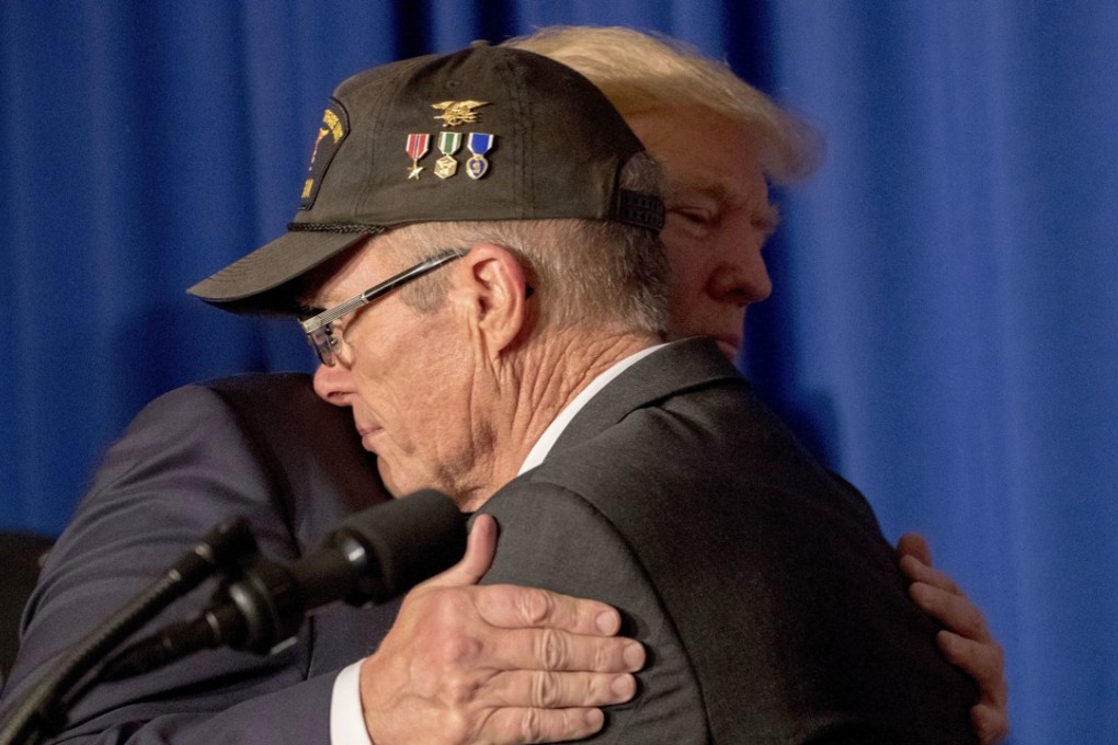 US President Donald Trump hugs Vietnam veteran Max Morgan. Ex-servicemen and women now based in the Philippines – Trump’s next stop on his Asia tour – have expressed support for the US president. Photo: AP