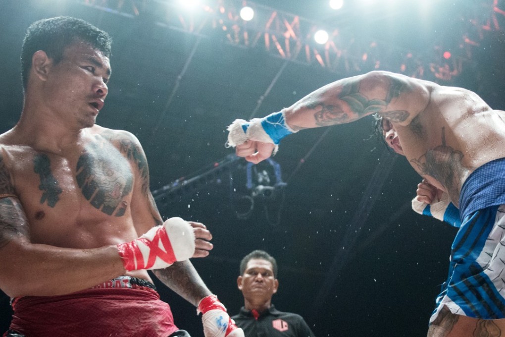 Lethwei champion Too Too ducks away from Australian Michael Badato during their World Lethwei Championship title bout in Myanmar. Photos: World Lethwei Championship