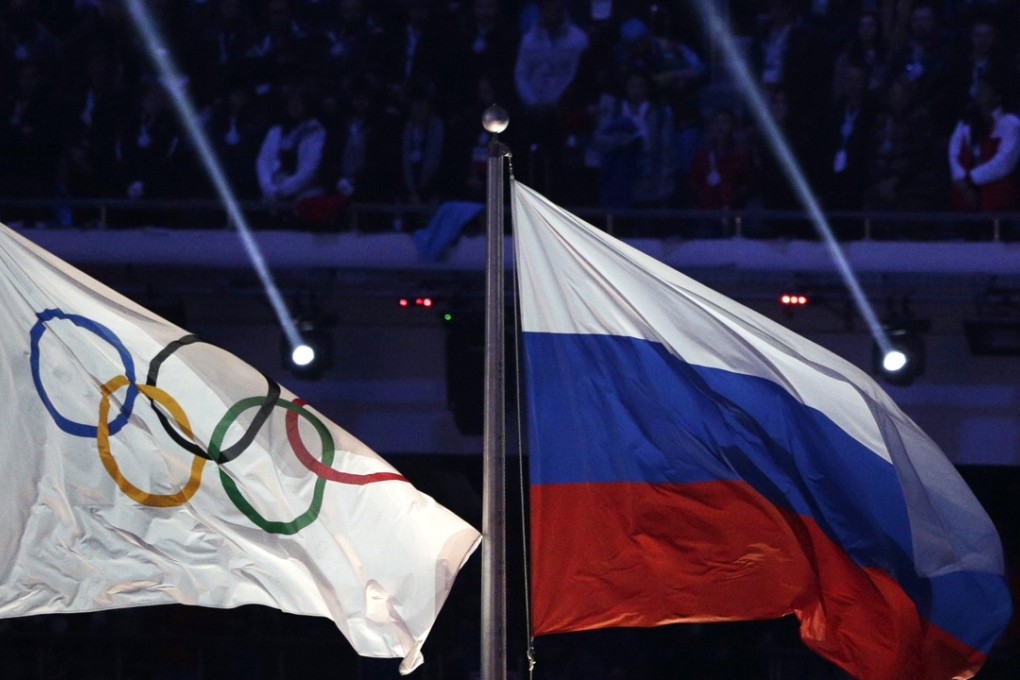 The Russian national flag flies after it is hoisted next to the Olympic flag during the closing ceremony of the 2014 Winter Olympics in Sochi, Russia. The World Anti-Doping Agency said it has a database proving widespread Russian doping. Photo: AP