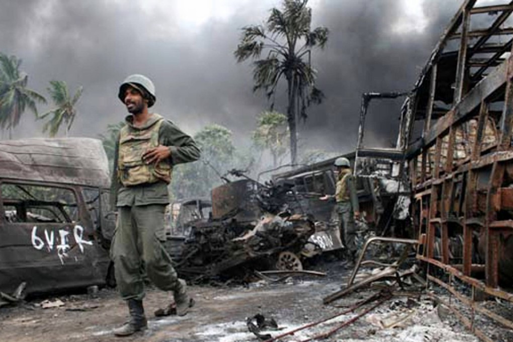 Sri Lankan troops walking among debris inside the war zone at the end of the civil war in 2009. Photo: AFP
