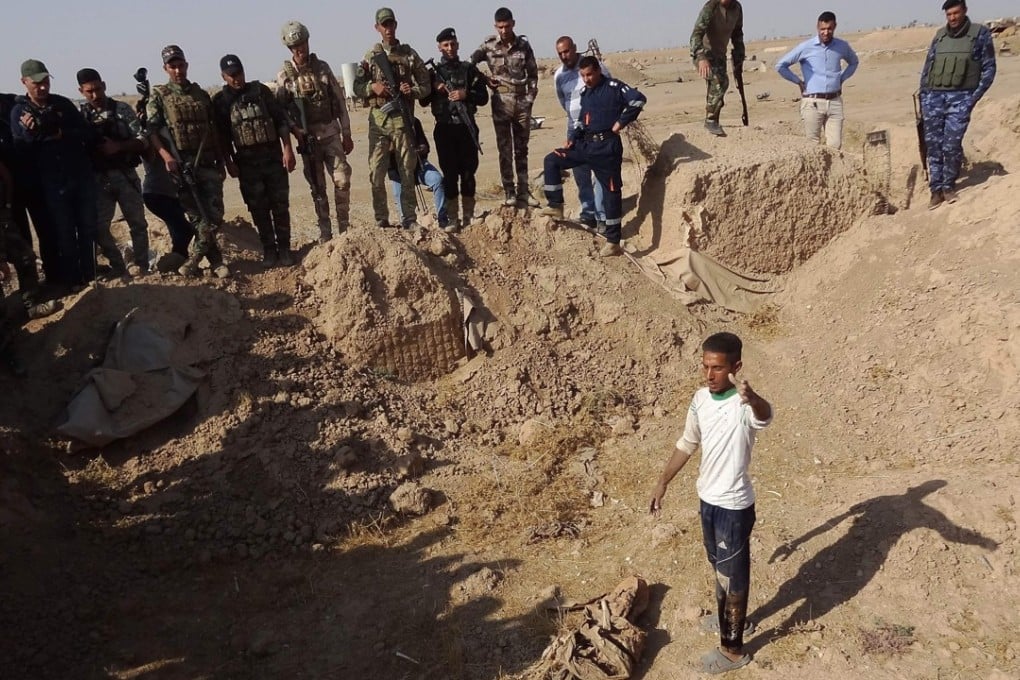 Iraqi forces search the site of a suspected mass grave containing the remains of victims of Islamic State, near a former military base south west of Hawija. Photo: AFP