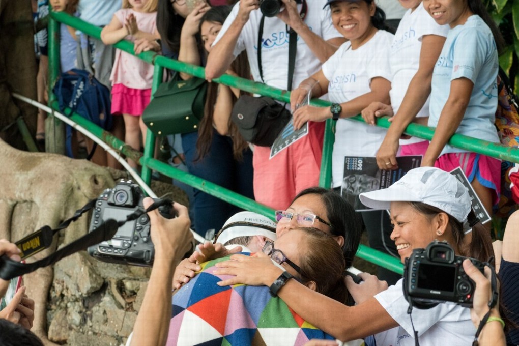 Simon Holliday is greeted by well wisherss after completing his feat at Sai Wan Swimming Shed: Photos: Handout