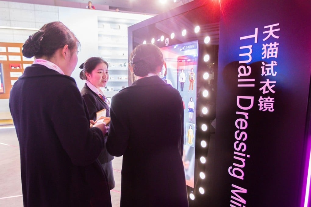 An electronic screen at a T-Mall exhibition showcases online fitting during the Singles’ Day in Shanghai on November 11, 2017. Photo: AFP