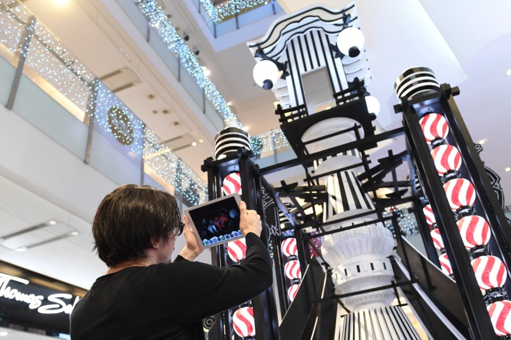 French artist Nicolas Buffe uses augmented reality to reveal images in his looming rocket lantern sculpture at K11 Mall.