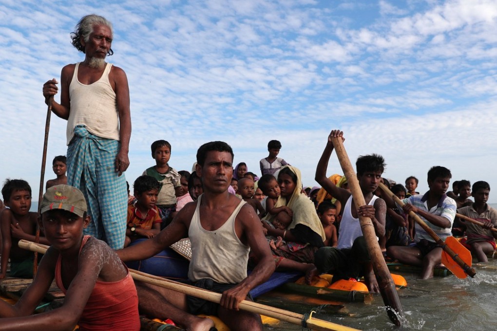 Rohingya refugees cross the Naf River with an improvised raft to reach Bangladesh. Photo: Reuters