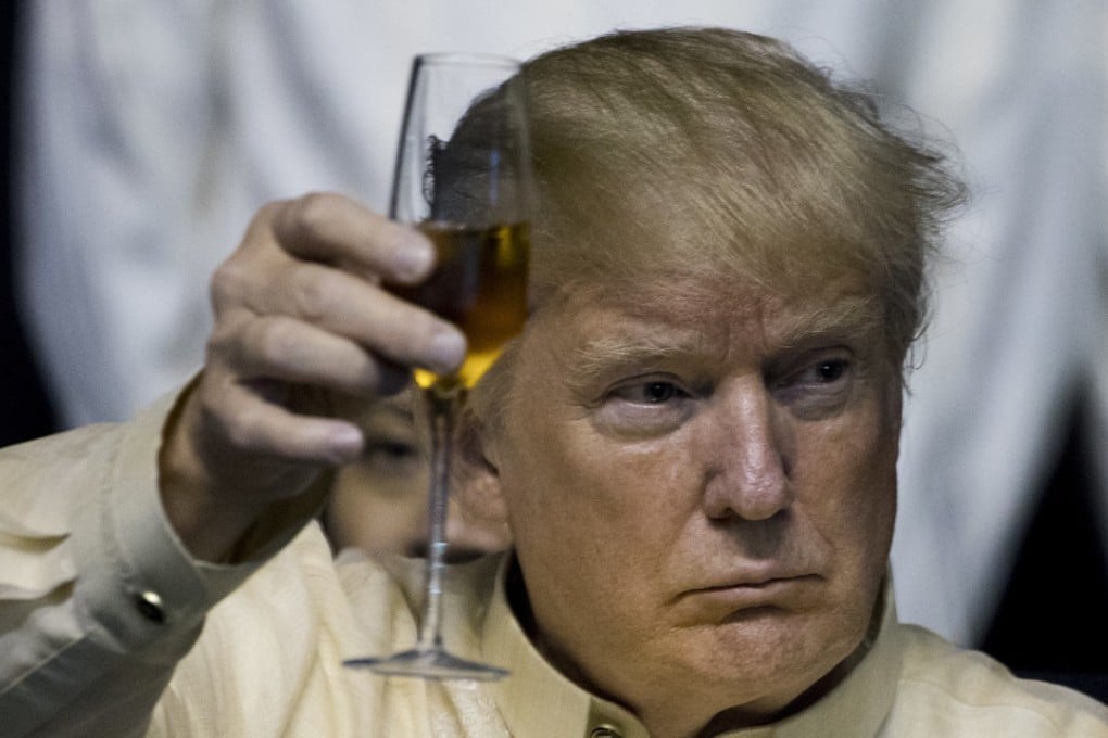 US President Donald Trump holds up his glass as Philippines President Rodrigo Duterte (not pictured) gives a toast at an Asean Summit dinner on November 12, in Manila. Photo: AP