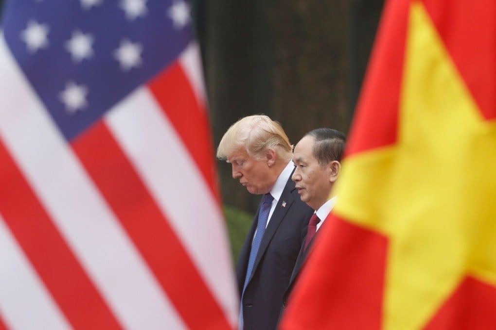 US President Donald Trump meets Vietnamese President Tran Dai Quang at the Presidential Palace in Hanoi on Saturday. Photo: AFP