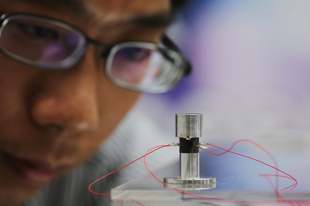 Ping Guo, Assistant Professor, Department of Mechanical and Automation Engineering at the Chinese University of Hong Kong, shows a prototype of a self levitating device last month. Photo: Dickson Lee
