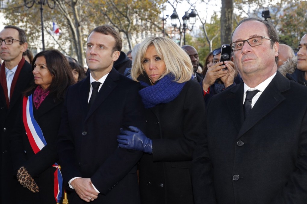 French President Emmanuel Macron, his wife Brigitte Macron, and former French president Francois Hollande. Photo: EPA