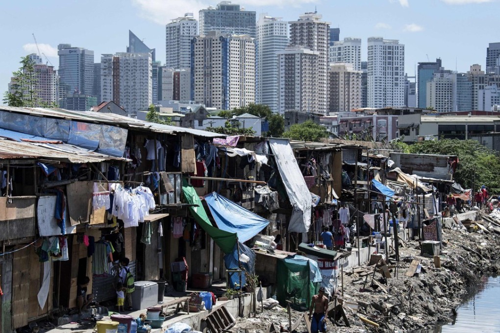 A slum in Manila with the financial district seen in the background. Photo: AFP