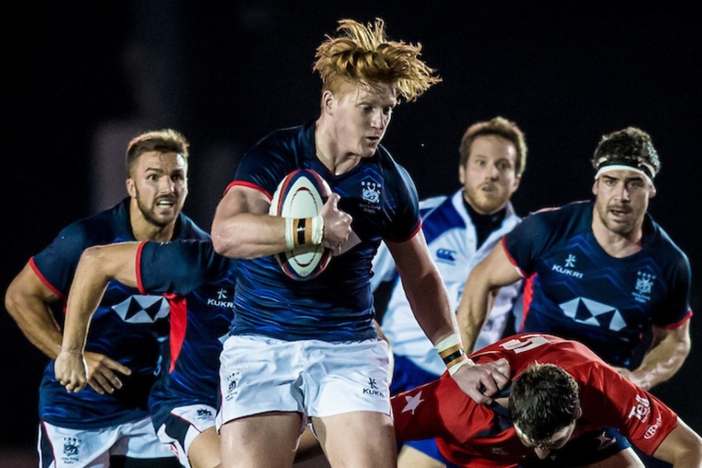 Hong Kong's Sam Purvis attempts to bust open the Chile defence. Photos: HKRU