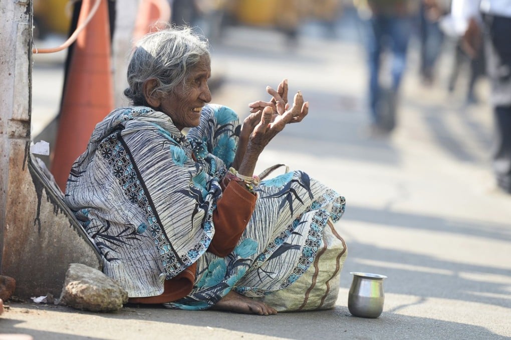 A woman begging on the side of the road in Hyderabad. Photo: AFP