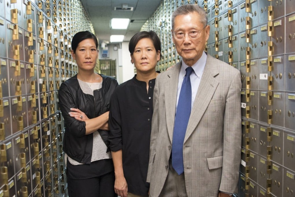 From left: Vera Sung, Jill Sung and their father Thomas Sung in the safety deposit box area of Abacus Federal Savings Bank in New York's Chinatown. Photo: Sean Lyness, courtesy Kartemquin Films