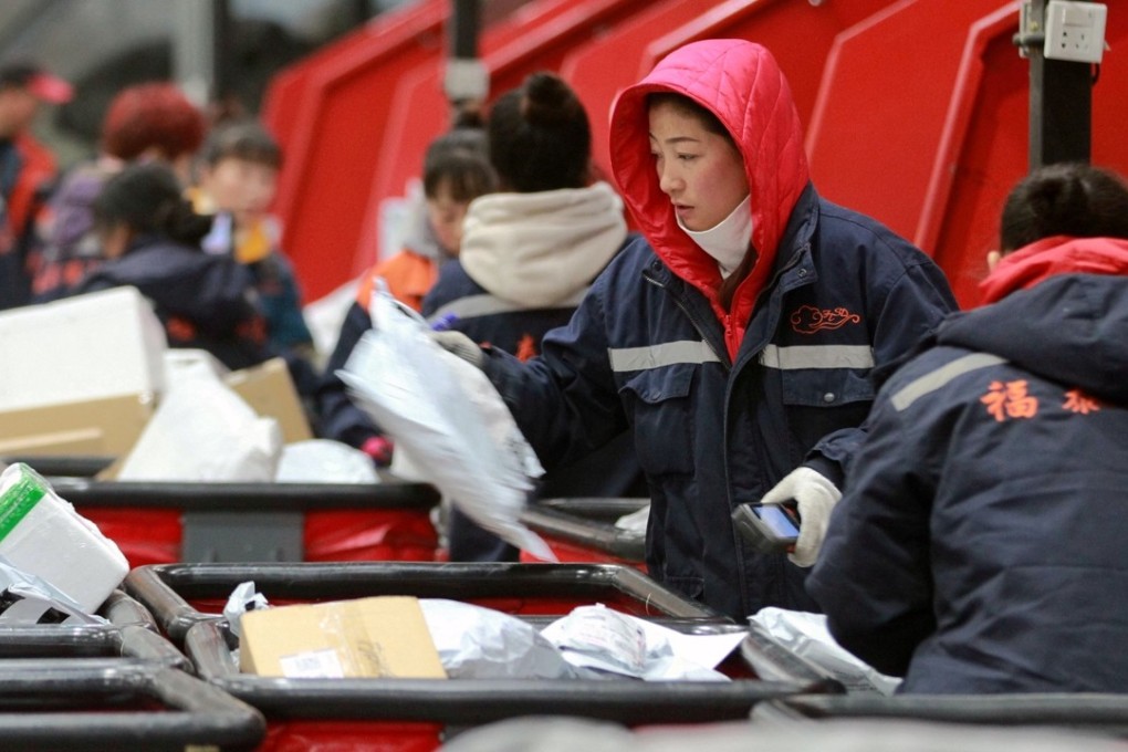 Employees scan boxes and parcels at the logistic centre of an express delivery company, after the Singles’ Day online shopping festival, in Harbin, Heilongjiang province. Photo: Reuters