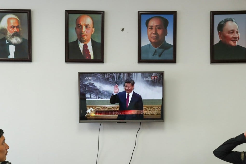 Framed portraits (from the left) of German philosopher Karl Marx, Soviet Union founder Vladimir Lenin, and China’s former leaders Mao Zedong and Deng Xiaoping hang above a screen showing a news broadcast of China's President Xi Jinping, as Communist Party members gather to watch in Wenzhou, Zhejiang province, on October 25. Photo: Reuters