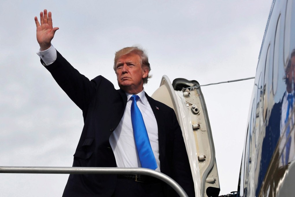 US President Donald Trump boards Air Force One to return home from Manila in the Philippines on Tuesday. Photo: Reuters