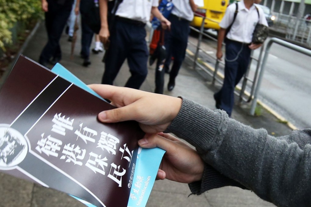 Pupils handing out fliers at a school on Tuesday. Photo: David Wong