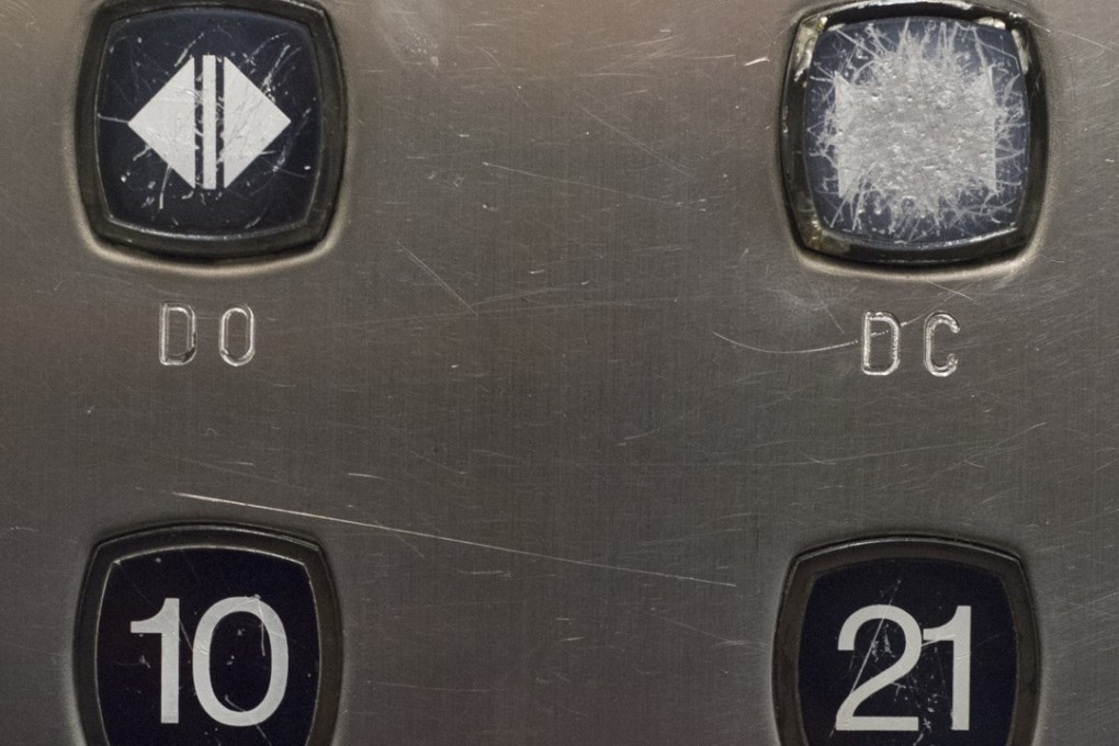 A well-worn button highlights the tendency of most people entering lifts in Hong Kong. Photo: Antony Dickson
