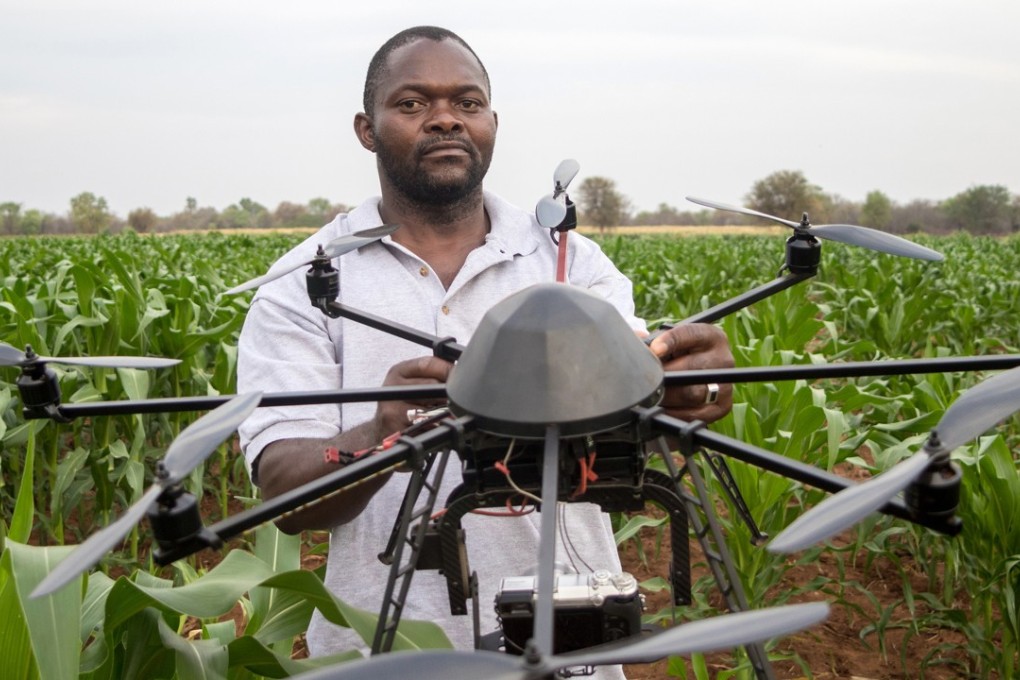 A technician holds a drone used to scout a plot of a heat-tolerant hybrid corn growing at the Chiredzi Research Station, in Zimbabwe, in October 2016. Africa’s largest employer is agriculture. In China, agriculture was modernised by granting more autonomy to farmers, alongside state investment in food-processing facilities. Photo: AFP