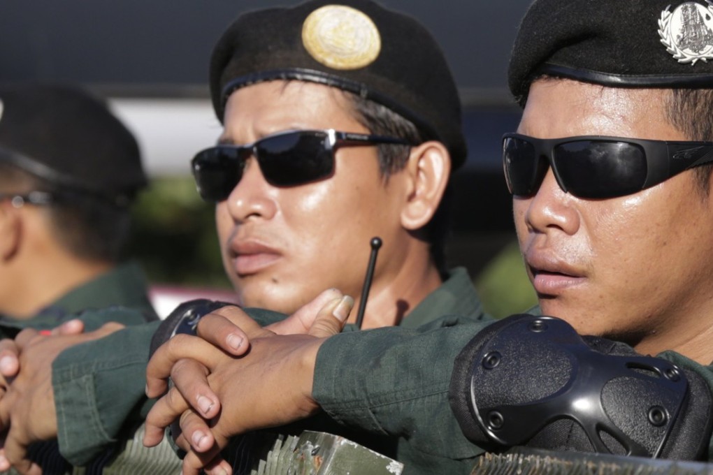 Cambodian police officers stand guard on a street near the Supreme Court in Phnom Penh. Photo: EPA