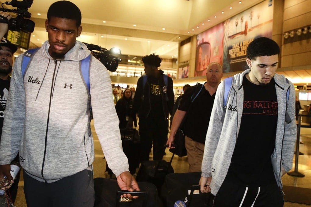 UCLA basketball players Cody Riley (left), LiAngelo Ball (right) and Jalen Hill (background centre), are surrounded by the media as they leave Los Angeles International Airport on Tuesday. Photo: AP