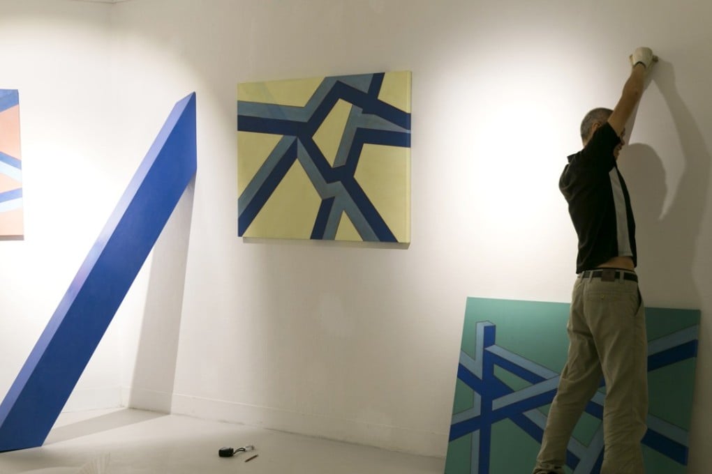 Art student Clint Ho setting up an exhibition of his work. Photo: Handout