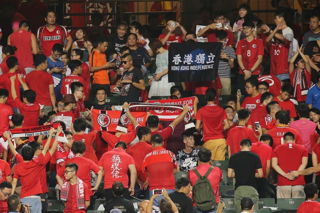 Young Hong Kong soccer fans turn their backs on the pitch, with some holding up an independence banner, as the national anthem plays before a 2019 Asian Cup qualification match with Malaysia, on October 10. Photo: Dickson Lee