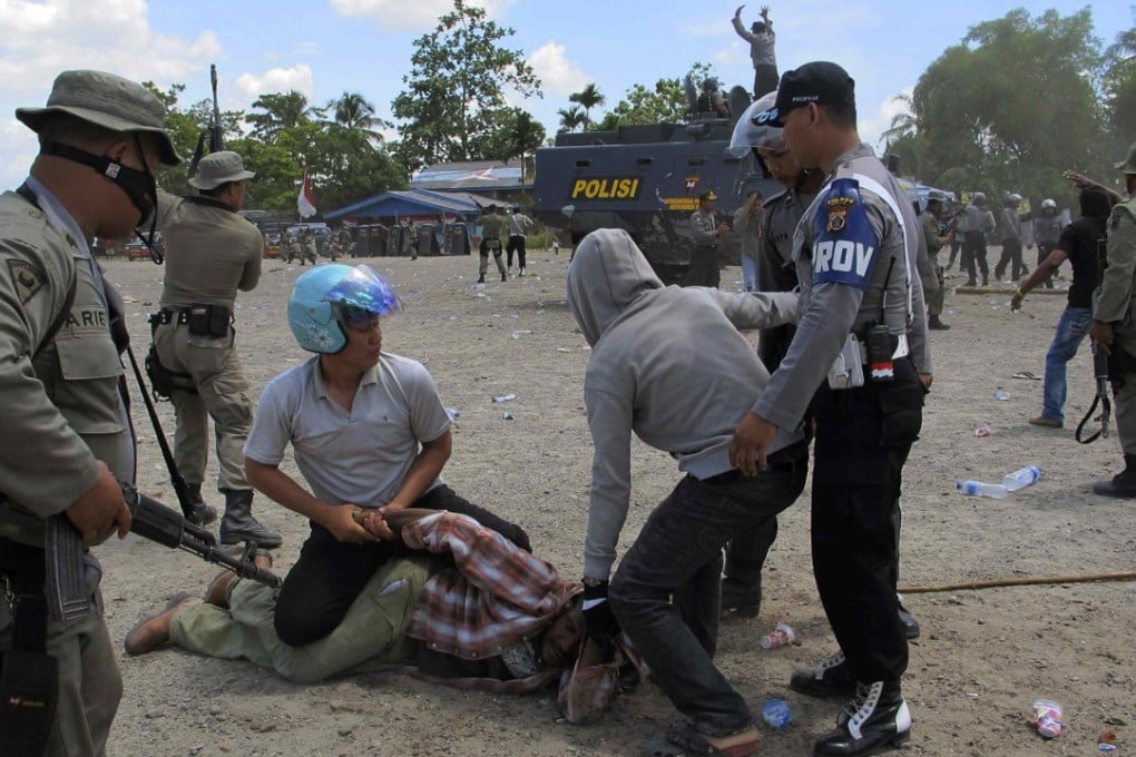 Police arrest a man in Timika after dispersing hundreds of West Papuans attending a ceremony to commemorate the 50th anniversary of West Papua’s independence from Dutch rule. Photo: Reuters