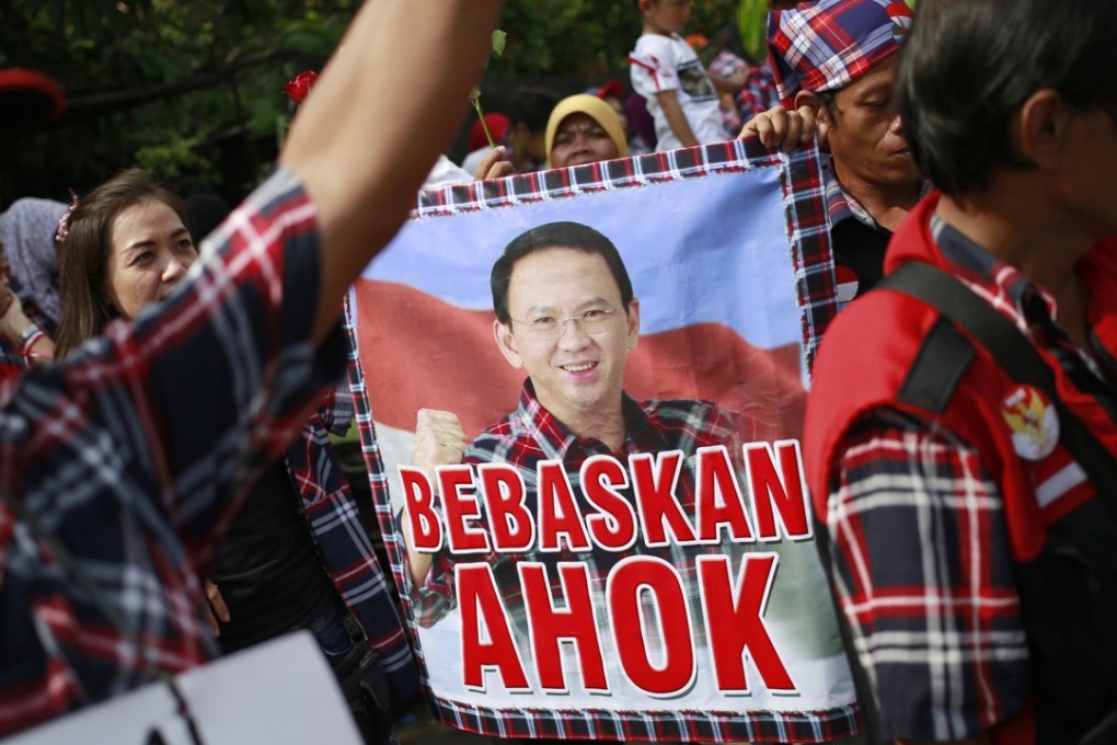 Supporters of former Jakarta governor Basuki Tjahaja Purnama, aka Ahok, call for his release during a rally in Jakarta, on May 9, the day an Indonesian court sentenced him to two years in prison for blasphemy. Picture: AP