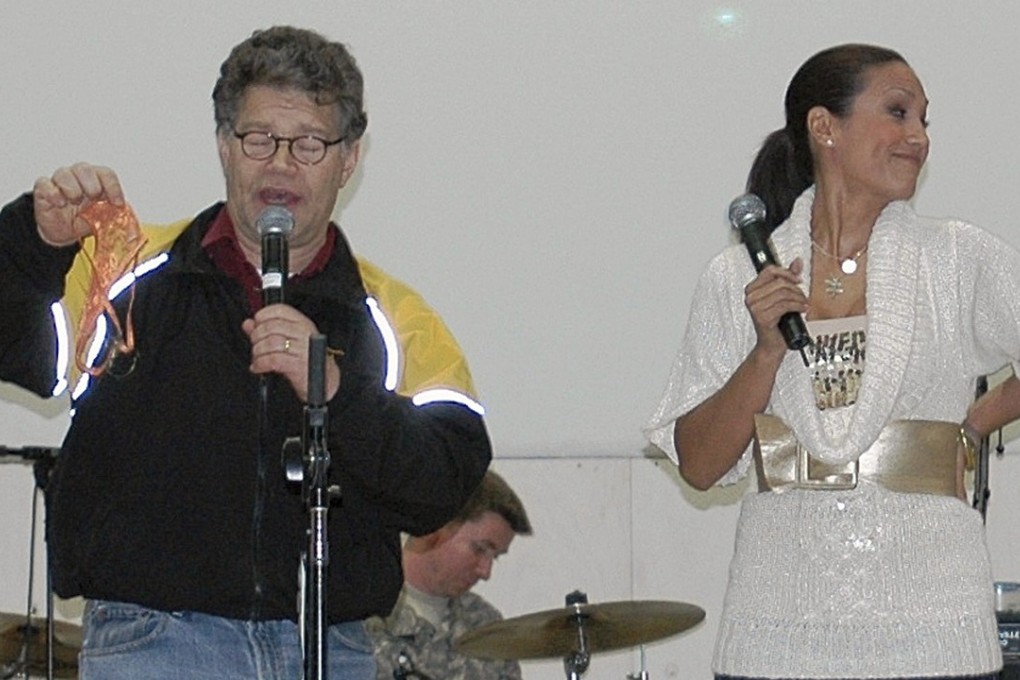 In this image provided by the US Army, then-comedian Al Franken and sports commentator Leeann Tweeden perform a comic skit at Forward Operating Base Marez in Mosul, Iraq, on December 16, 2006. Franken, now a US Senator, apologised after Tweeden accused him of forcibly kissing her during the tour. Photo: US Army via AP
