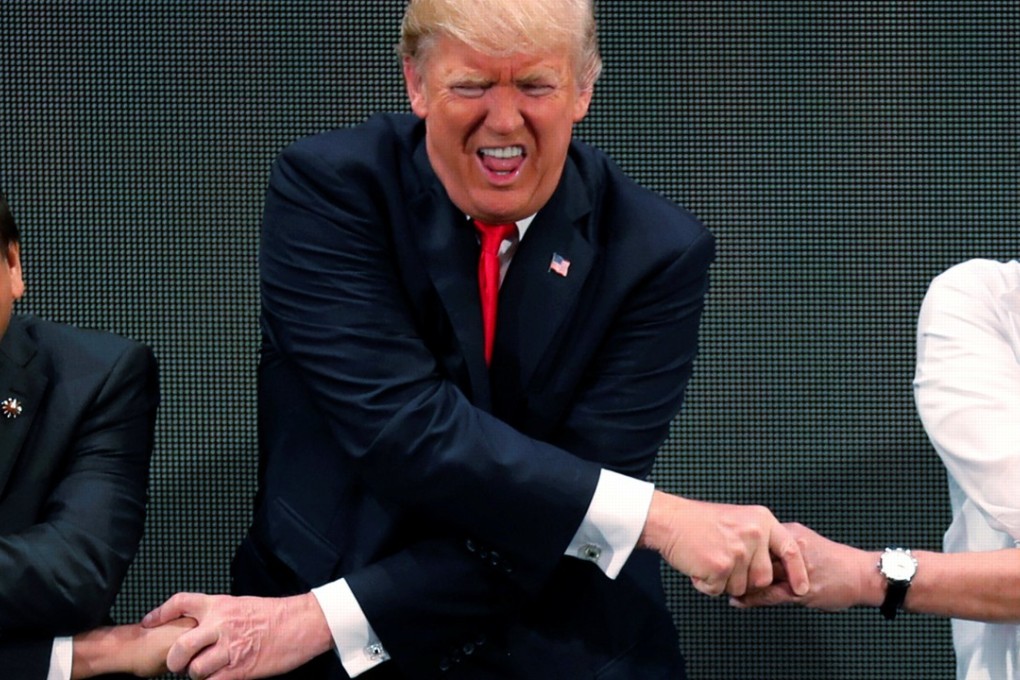 US President Donald Trump shakes hands with Vietnamese Prime Minister Nguyen Xuan Phuc and President of the Philippines Rodrigo Duterte at the Asean Summit in Manila. Photo: Reuters