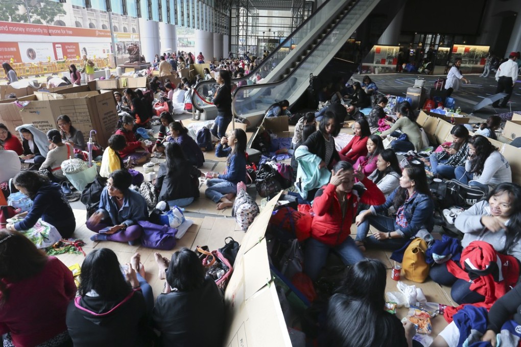 Filipino maids or domestic helpers are pictured during a weekend gathering on a street in Hong Kong, where they already have the right to work. Many more work illegally over the border on the mainland. Photo: SCMP