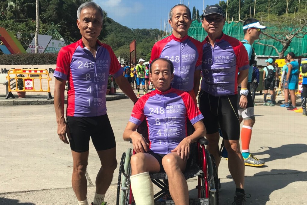 Tsang Chin (in wheelchair) is surrounded by his team. Photos: Andrew McNicol