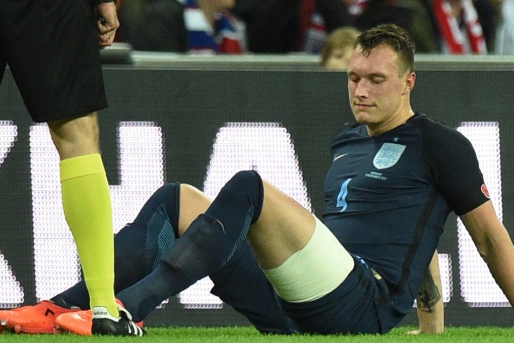 Phil Jones sits on the turf after suffering another injury. Photo: EPA