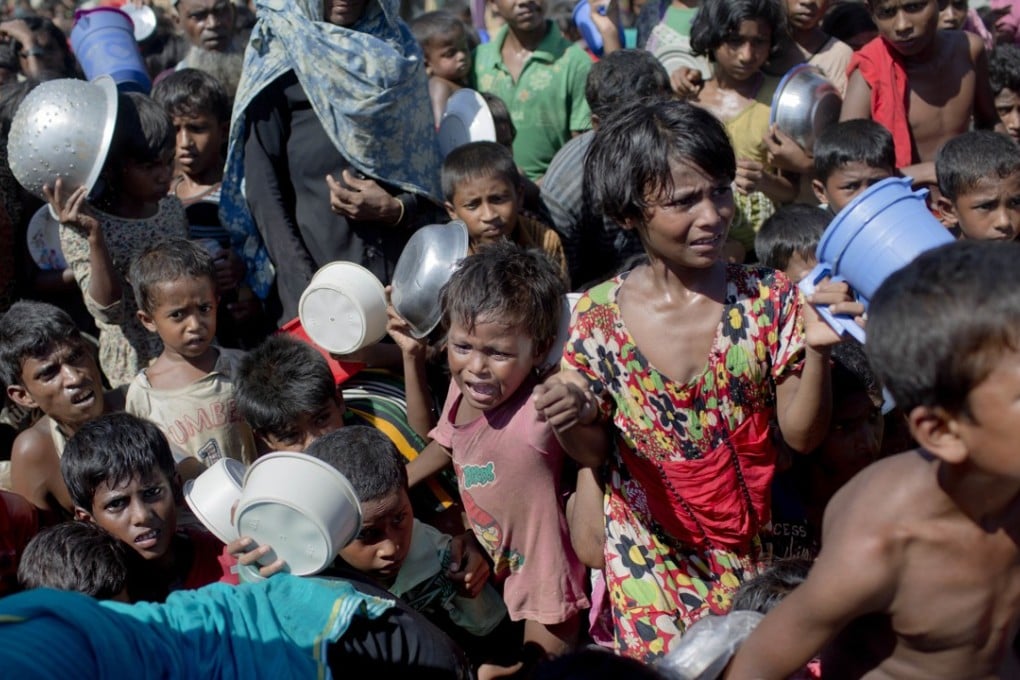 Rohingya children wait at a refugee camp in Bangladesh. The conflict has displaced 600,000 people and has been described by the UN as tantamount to ethnic cleansing. Photo: AP