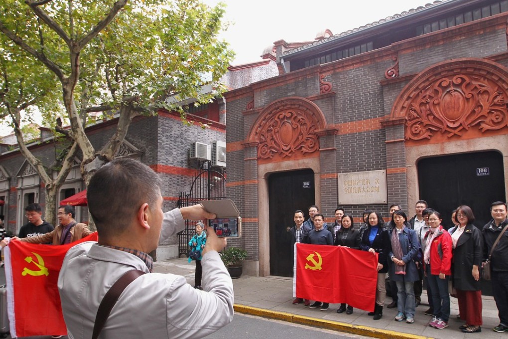 Visitors pose outside the site of the Communist Party’s first congress in Shanghai. Photo: Simon Song