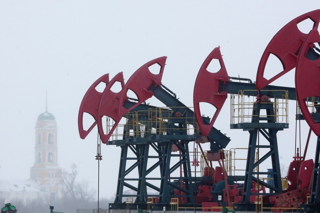 A worker passes a line of oil pumping jacks in the Bashneft oilfield outside the village of Nikolo-Beryozovka near Neftekamsk in Russia. The recent acquisition spree by Chinese firms in Russian energy and commodities companies is set to continue into next year, according to a senior banker at the Moscow-based, Russian state-backed investment firm VTB Capital. Photo: Bloomberg