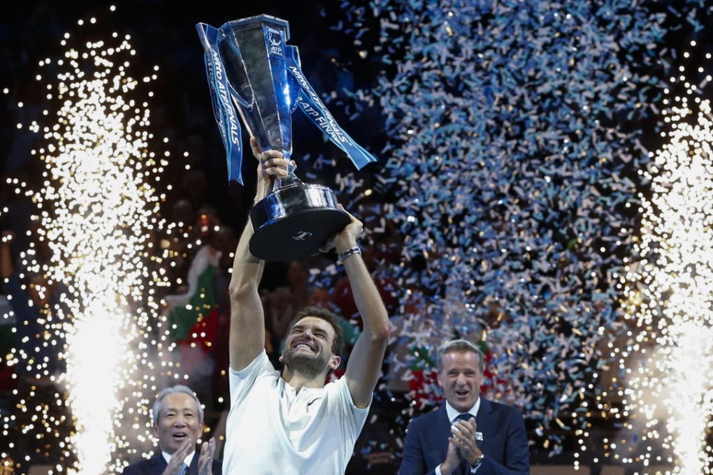 Grigor Dimitrov of Bulgaria celebrates during the trophy ceremony after the final of the ATP Finals. Photo: Xinhua
