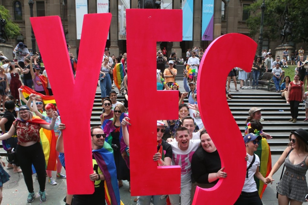 Celebrations in Melbourne after the announcement of the results of a postal survey on legalising same-sex marriage, in front of the State Library of Victoria on November 15. More than 60 per cent of Australians voted in favour in the voluntary survey. Photo: EPA-EFE