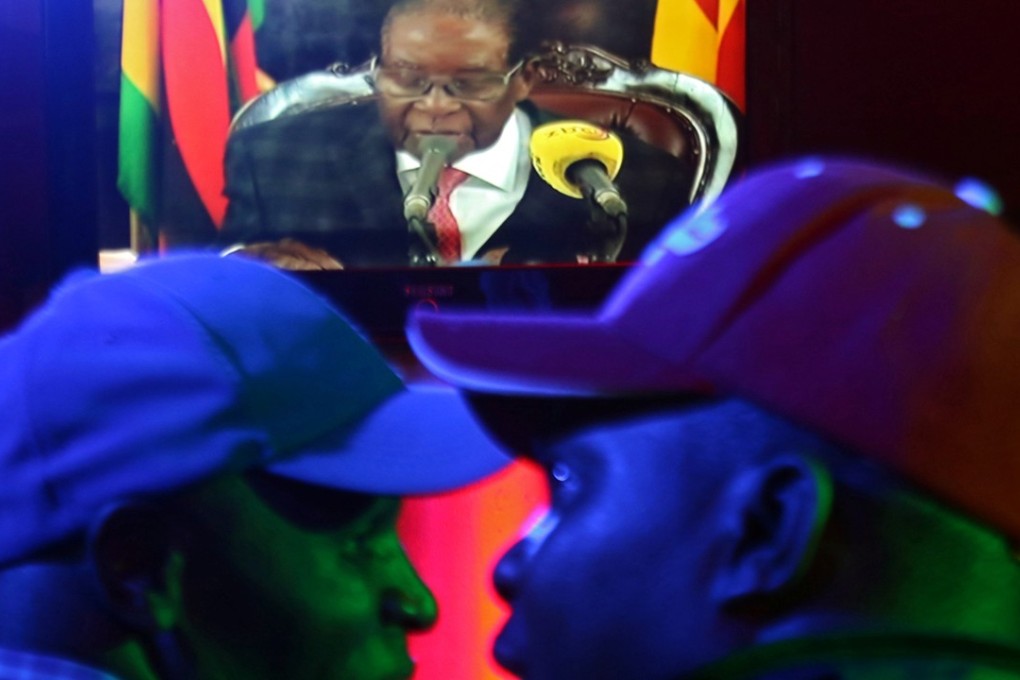 People watch as Zimbabwean President Robert Mugabe addresses the nation on television, at a bar in Harare, Zimbabwe. Photo: Reuters