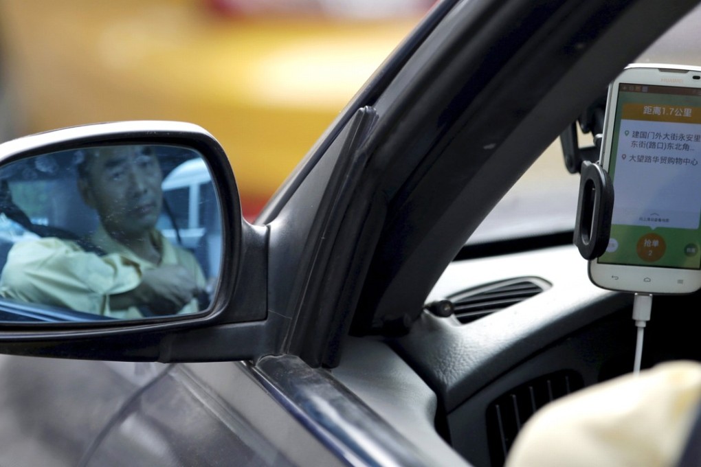A taxi driver uses the Didi Chuxing car-hailing application in Beijing. The premium chauffeur car market in China is expected to be worth 500 billion yuan by 2020. Photo: Reuters