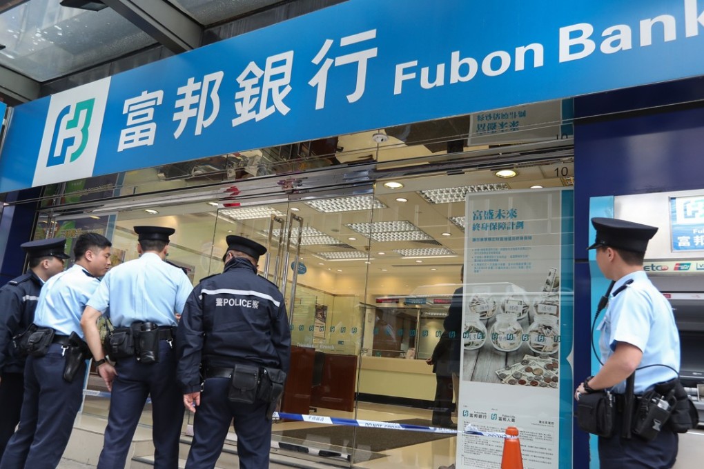 Hong Kong police officers investigate a robbery case at Fubon Bank in Tsim Sha Tsui in December 2016. Voiceprint recognition technology will make it easier for law enforcement to identify criminals. Photo: Nora Tam