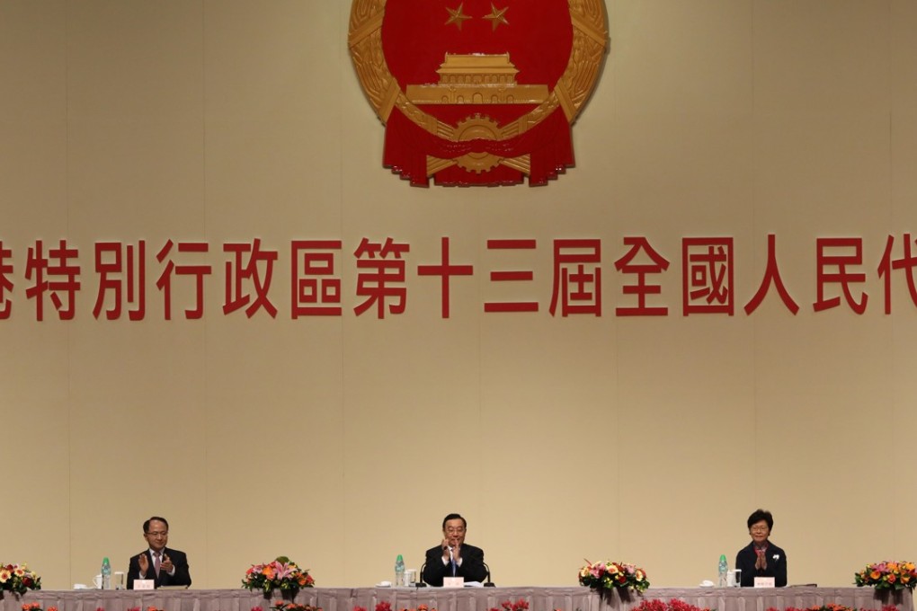 (L to R) Wang Zhemin, head of the central government’s liaison office in Hong Kong ; Wang Chen, secretary-general and Vice-chairman of the National People’s Congress Standing Committee; and Chief Executive Carrie Lam Cheng Yuet-ngor at the local NPC plenary session on Wednesday. Photo: Sam Tsang