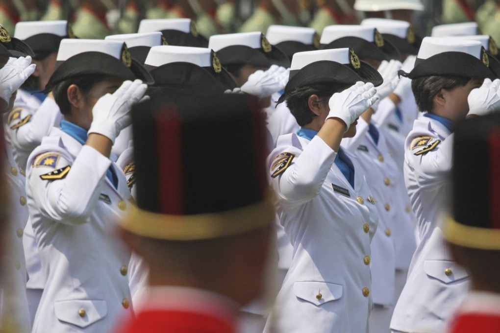Female members of Indonesia’s navy salute during a ceremony commemorating Independence Day at Merdeka Palace in Jakarta. Photo: AP