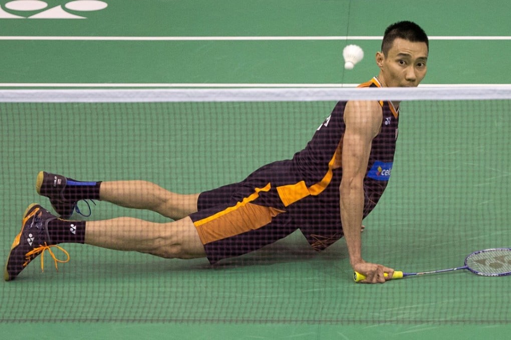 Malaysia's Lee Chong Wei watches his shot against China's Tian Houwei after he slipped during their first round men's singles match at the Hong Kong Open. Photos: AFP