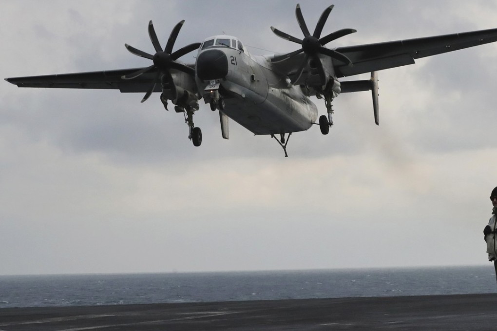 FILE – In this March 14, 2017, file photo, a US Navy C-2 Greyhound approaches the deck of the Nimitz-class aircraft carrier USS Carl Vinson during the annual joint military exercise called Foal Eagle between South Korea and the United States at an unidentified location in the international waters, east of the Korean Peninsula. A similar type of the US Navy plane carrying 11 crew and passengers crashed into the Pacific Ocean on Wednesday, November 22, 2017, while on the way to the USS Ronald Reagan aircraft carrier, the Navy said. (AP Photo/Lee Jin-man, File)