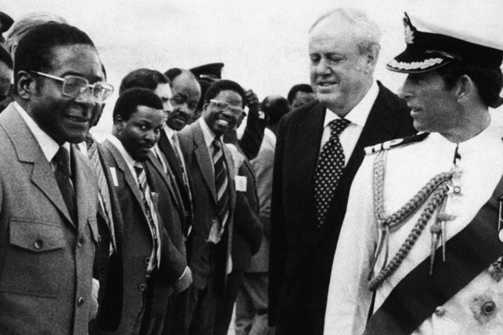 In this April 16, 1980, file photo, Britain's Prince Charles, right, speaks with Robert Mugabe, left, while British Governor Christopher Soames and the Rhodesian cabinet look on, in Salisbury, now Harare. The next day, Mugabe was sworn in as prime minister of the new and independent Zimbabwe. Photo: AP
