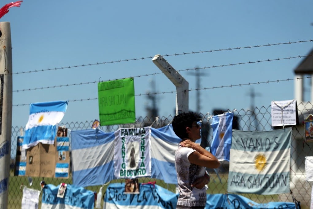 A woman looks at messages and signs in support of the 44 crew members of the missing at sea in the ARA San Juan submarine, placed on a fence at an Argentine Naval Base in Mar del Plata, on November 22, 2017. Photo: Reuters